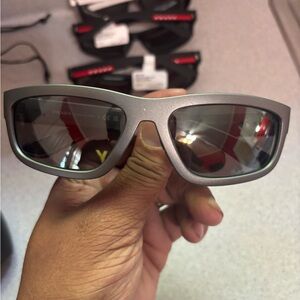 Silver PRADA Linea Rossa sunglasses with dark gray lenses